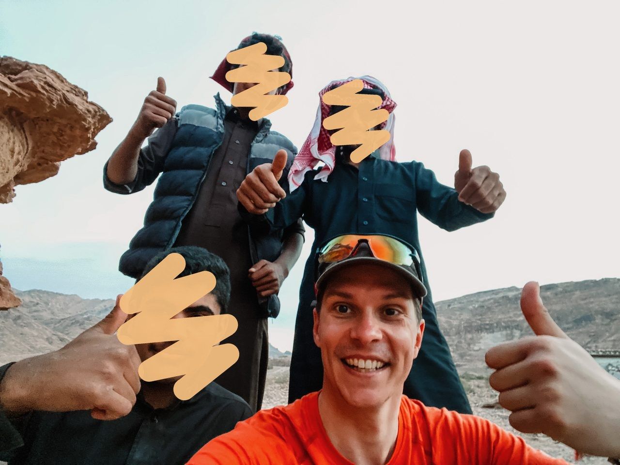 Polle with a group of men in the Jordan desert, all thumbs up